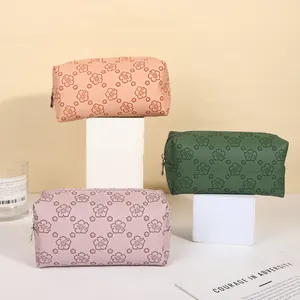 Vintage floral embossed PU leather makeup bags in pink, green, and purple styles