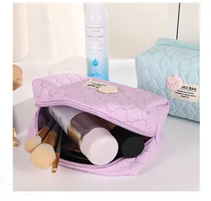 Detail of quilted bubble bear makeup bags showing storage space and cute plush bear tags