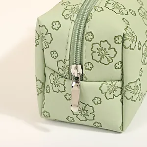 Floral embossed light green PU leather makeup bag with silver metal zipper detail