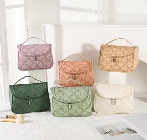 Detail of embossed floral patterns on colorful PU leather cosmetic travel bags