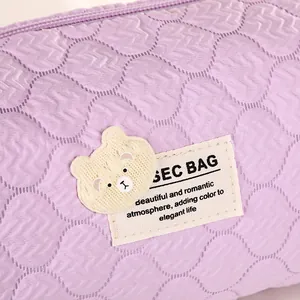 Quilted purple bubble bear cosmetic bag with wavy stitching and cute bear patch detail