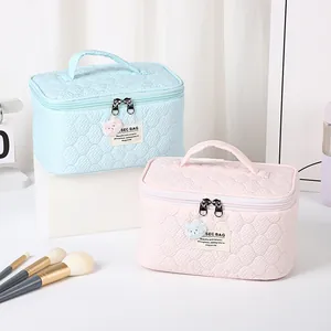 Quilted bear cosmetic bag set in pastel blue and pink with portable handle and bear charm