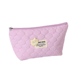 Quilted lavender cosmetic bag with cartoon bear patch and secure zipper closure