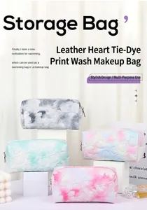 Macro shot of colorful heart-quilted leather makeup bags with soft tie-dye print details