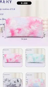 Detailed size guide of quilted tie-dye cosmetic bag with heart patterns and zipper