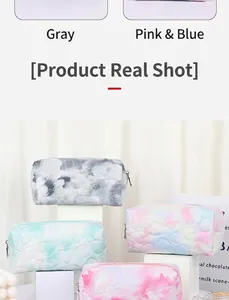 Detail of pastel heart embossed makeup bags in grey, pink, and mint green colors