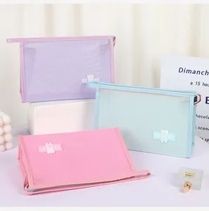 Three macaron-colored mesh toiletry bags with bear badge and portable leather handles