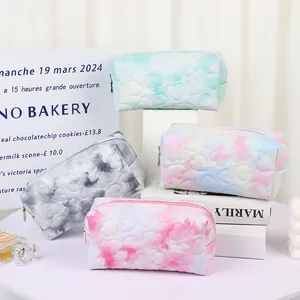 Quilted heart patterned makeup bags in four gradient colors on decorative stands