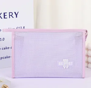 Detail of light purple mesh cosmetic bag with bear patch and handle in home setting