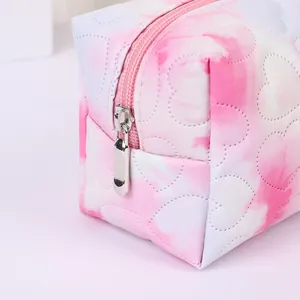 Quilted heart pattern makeup bag with pink gradient finish and metal zipper closure