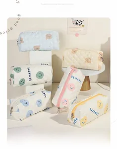 Gros plan détaillé des trousses de maquillage matelassées avec motifs ours et fermetures éclair