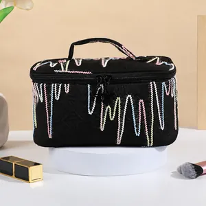 Large black cosmetic bag with wave embroidery and star zipper, dimensions 21x14x12cm