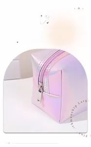 Close-up of smooth silver metal zipper on a holographic laser PU leather makeup bag