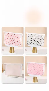 Detail showing set of four translucent heart print makeup bags in various colors