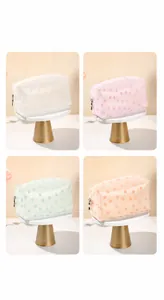 Macro detail of daisy print patterns on colorful frosted translucent cosmetic bags