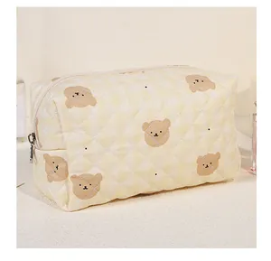 Detail of quilted bear cosmetic bag showing premium fabric and metal zipper pull