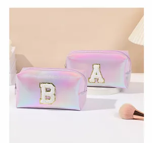 Detail of holographic pink cosmetic bags with sequin letter A and B embroidery patches