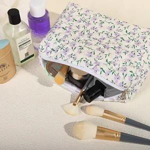 Gewatteerde bloemen make-up tas in beige met paars patroon en grote ritssluiting