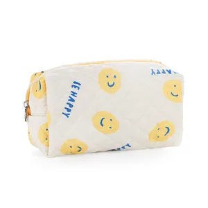 Quilted beige cosmetic bag with yellow smiley face and BE HAPPY print design