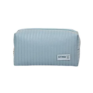 Light blue faux leather makeup bag with perforated texture and rabbit logo on white background