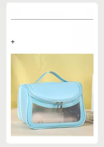 Detail view of sky blue cosmetic bag with transparent window and double metal zippers