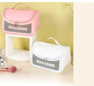 Close-up of pink and white washbags featuring a transparent window and double zippers