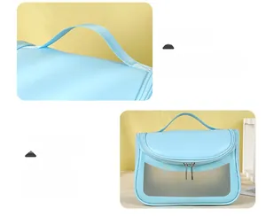 Detail of light blue waterproof wash bag with top handle and clear washbag lettering