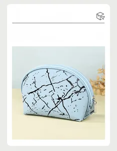 Detail view of a light blue marble pattern cosmetic bag with high-quality zipper and smooth finish