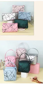 Macro view of marble pattern vanity bags in multiple colors with metallic zippers