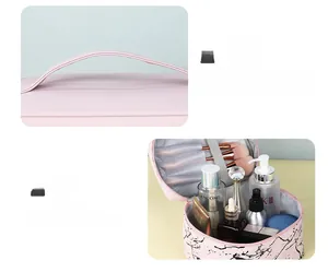 Detail showing marble makeup bag with wide handle and large interior with brush slots