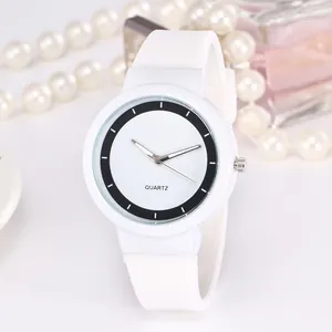 Minimalist white quartz watch with silicone strap and elegant accessories display