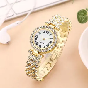 Close-up of golden quartz watch with sparkling crystals and Roman numeral dial