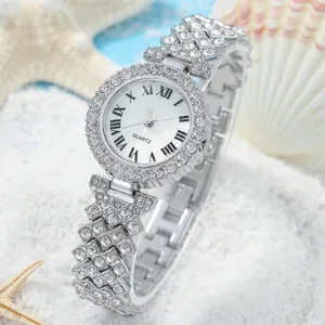 Close-up of a silver quartz watch with rhinestone bezel and Roman numerals in a seaside setup