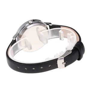 Women's minimalist fashion watch with black leather strap and silver metal case on white stand