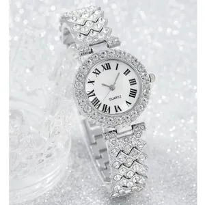 Macro view of luxury silver quartz watch featuring rhinestone-set bezel and Roman numerals