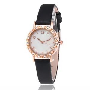 Close-up of rose gold watch case with star motifs and crystals on a black leather strap