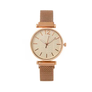 Women's rose gold quartz watch with leaf-patterned dial and magnetic mesh strap
