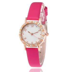Detailed close-up of rose gold watch case with rhinestone bezel and pink leather strap