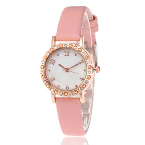 Detailed macro view of pink leather strap watch with star-shaped crystal bezel decoration
