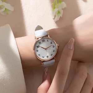 Close-up of a women's quartz watch with a rose gold case and light blue leather strap