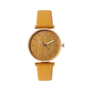 Women's quartz watch with mustard yellow leather strap and rose gold leaf pattern dial