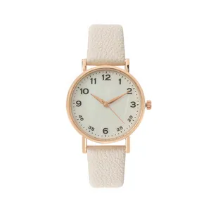 Macro view of rose gold quartz watch with cream dial and litchi texture leather strap