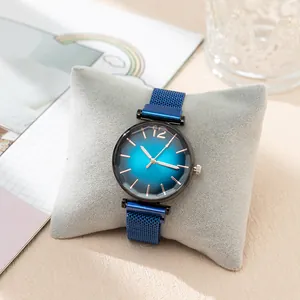 Detailed macro of a women's watch with blue gradient dial and Milanese mesh magnetic band