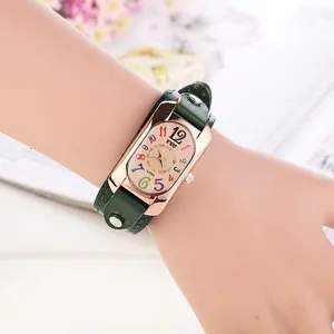 Detail of vintage square quartz watch with colorful numerals and green studded strap