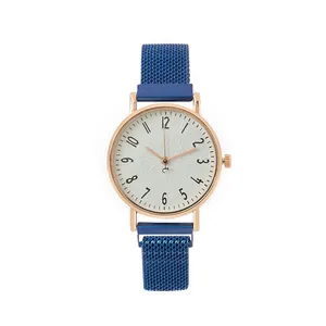 Detail of rose gold case and blue Milanese mesh strap on a minimalist quartz watch