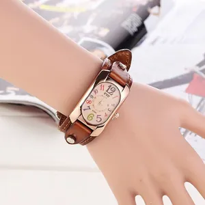 Close-up of retro wide leather band watch with colorful numerals and rose gold frame