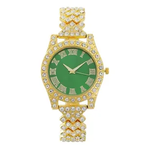 Detail of luxury gold watch with green Roman dial and pavé-set diamond bezel