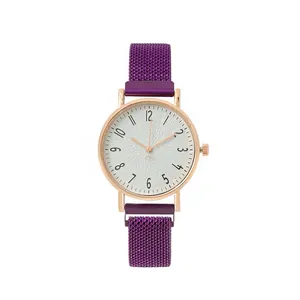 Detail of rose gold quartz watch with purple mesh band and magnetic closure clasp