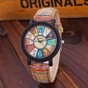 Retro quartz watch with multi-color dial and unique cork strap on dark wooden surface