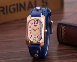 Detail of vintage watch featuring rose gold case, colorful numerals, and blue studded strap